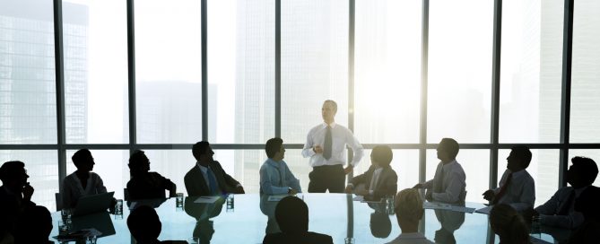 The leader of the business people giving a speech in a conference room.