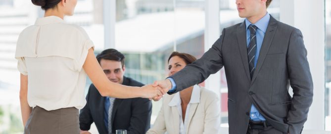 Handshake to seal a deal after a job recruitment meeting in an office