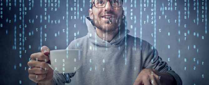 Young man sitting in front of a computer screen with binary code passing on the screen